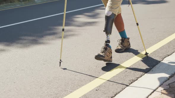 Sporty mixed race man with prosthetic leg hiking