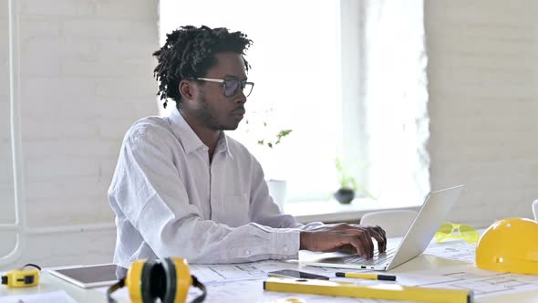 African Engineer Working on Laptop