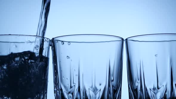 Water Filling Row of Glasses
