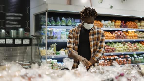 Man in Mask Push Cart Choosing Fruits and Vegetables in the Fresh Produce Section