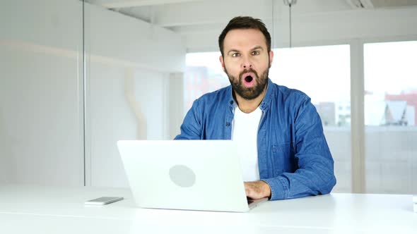 Amazed Man Working on Laptop in Shock Astonished