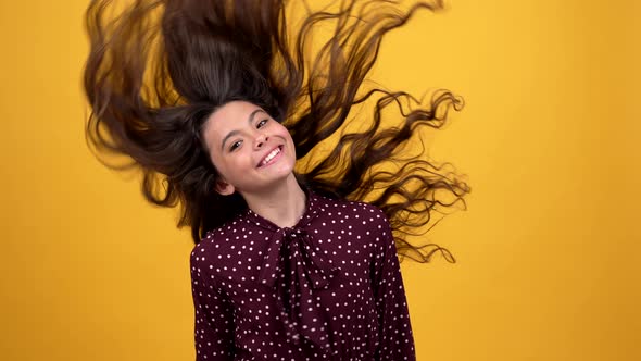 Happy Teen Girl Waving Her Beautiful Long Curly Hair Advertising Shampoo Hairdresser