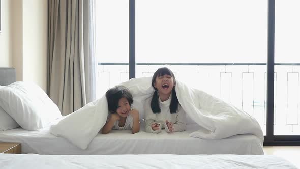Cute Asian Children Playing Hide And Seek On White Bed Slow Motion 