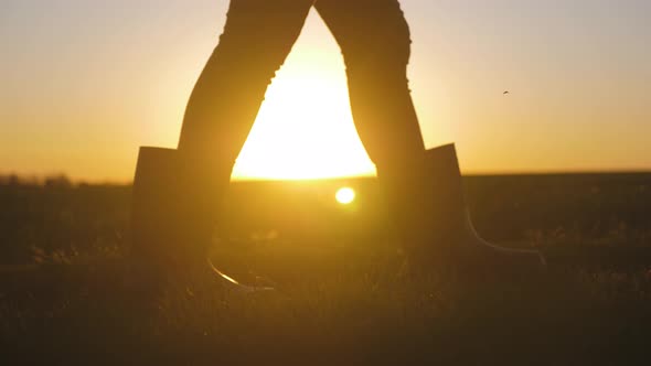 Farmer Girl Walking Beside Green Wheat Field Enjoying the Sun