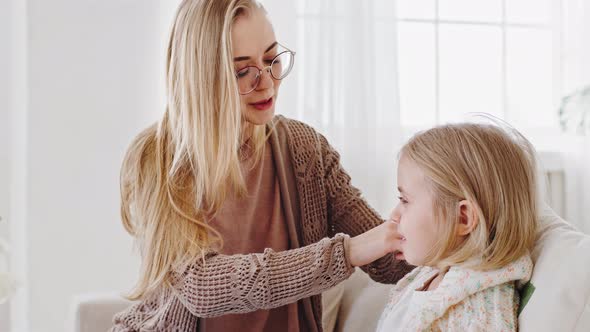 Young Caring Mother Single Mom Adult Woman Care for Child Combing Blonde Hair of Little Girl