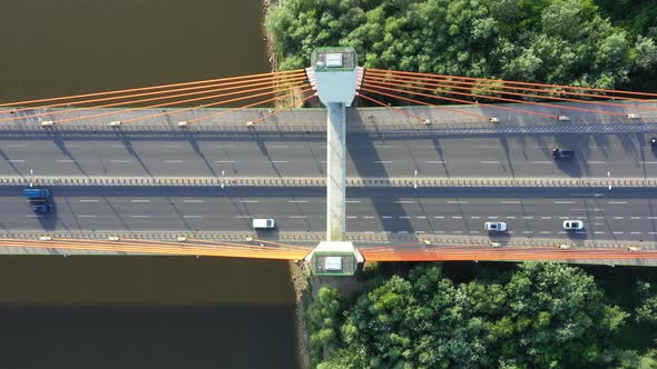 Aerial View of Traffic on highway road. Bridge over river. Dark water.