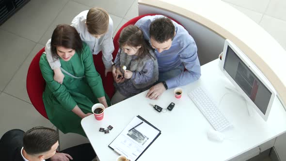 Mother Father and Child Buying Car at Dealership a New Family Auto