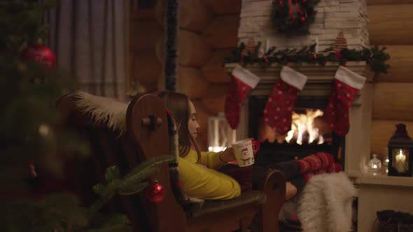 Woman in front of a fireplace alt