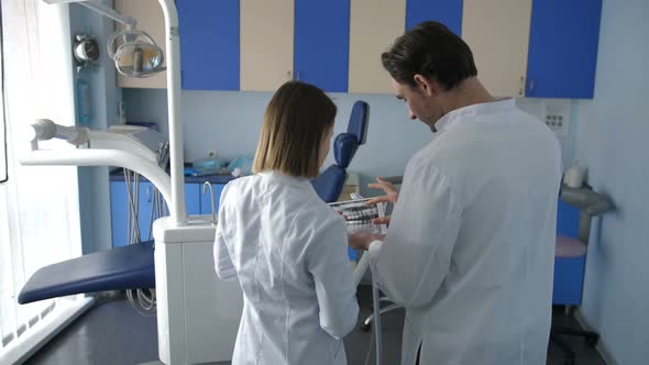 Back View of Dental Coworkers Using Tablet Pc