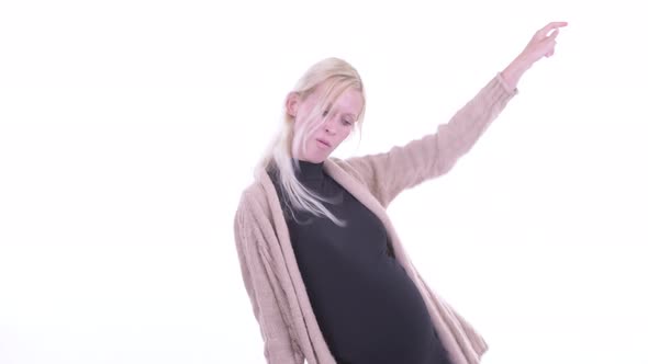 Happy Young Blonde Pregnant Woman Dancing