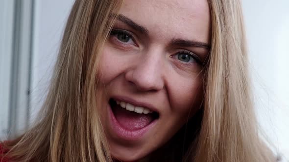 Young Blonde Girl in Red Sweater Holding Red Hearts Showing Emotions