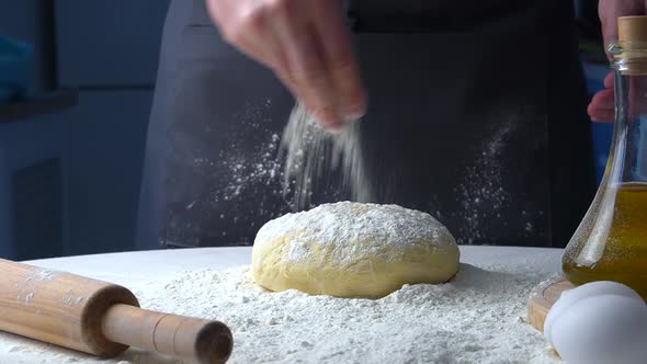 Chief Sprinkles Piece of Baking Dough with Flour
