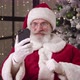 Goodnatured Elderly Santa Claus in His Residence Sitting on an Armchair Against Beautiful Christmas - VideoHive Item for Sale