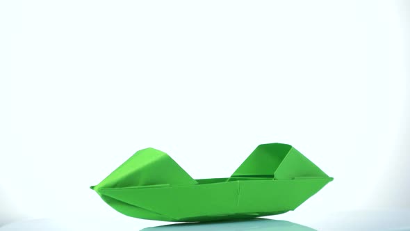 Green Paper Boat on White Background.