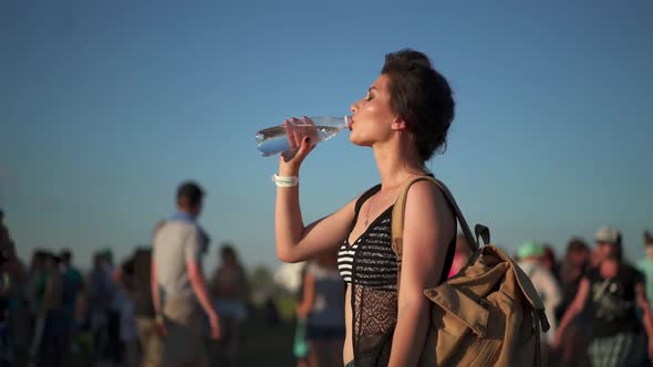 Pretty Multi Ethnic Woman Dancing at Sunset Light Among the Crowd of People at Rock Concert Festival