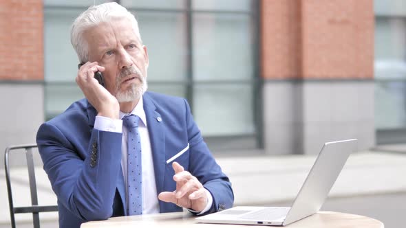 Old Businessman Talking on Phone Outdoor