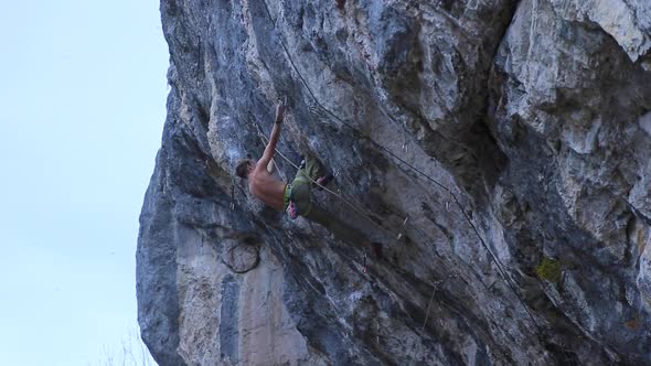 A man rock climbing up a mountain.