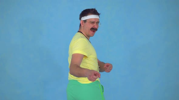 Portrait of Funny Man Trainer with a Mustache From the 80's on a Blue Background