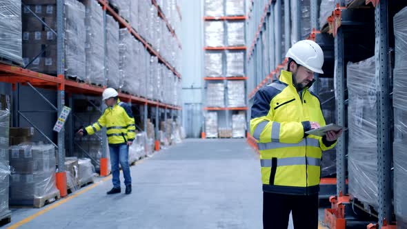 Worker male warehouse worker engineer man in a helmet working on the construction site