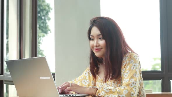 Young asian women in online meeting with laptop in desk