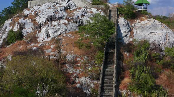 Aerial View of Wat Khao Samo Khon Temple with Hanuman Monkey God Statue on Top of Mountain in