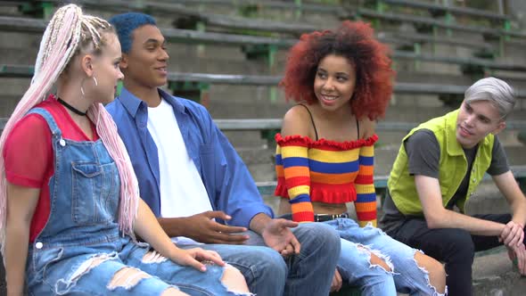 Multiethnic Group of Teenagers Talking Hanging Out Together Sitting Stadium, Fun