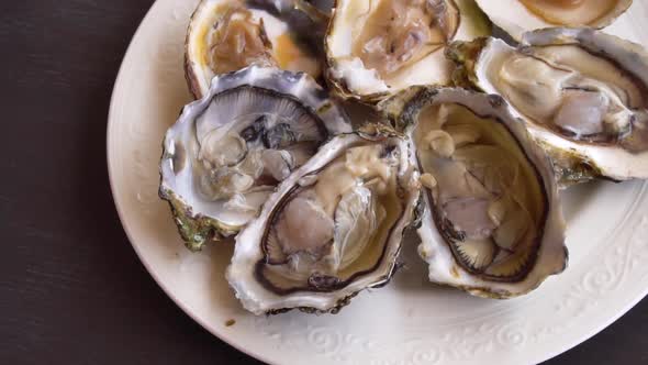 Squizing Lemon on Raw Oysters