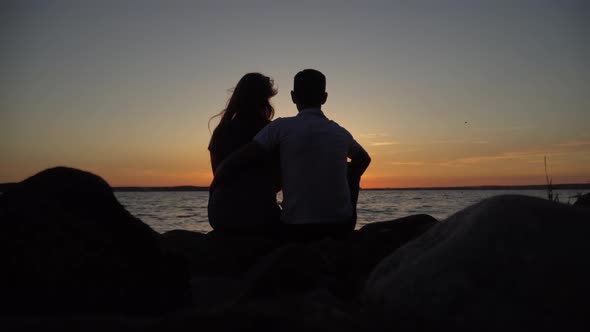 Couple in love sitting on the beach.