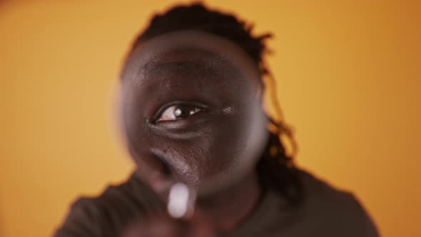 Portrait of an African Man Looking Through the Magnifying Glass