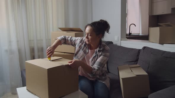 Adult Woman Carrying Cardboard Boxes While Moving to New Apartment