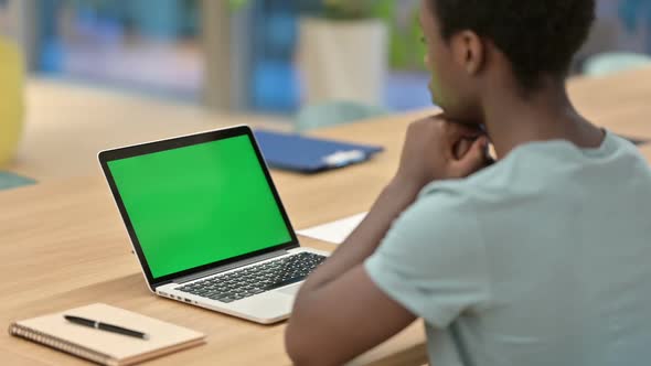 African Man Watching on Laptop with Chroma Screen