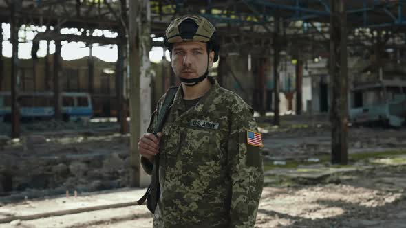 Officer From US Army Standing with Backpack at Steel Plant