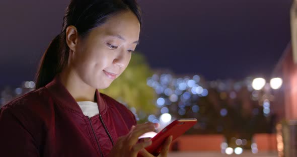 Woman use of smart phone at night