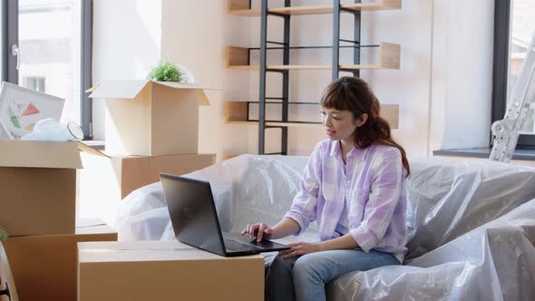 Woman with Laptop Moving Into New Home