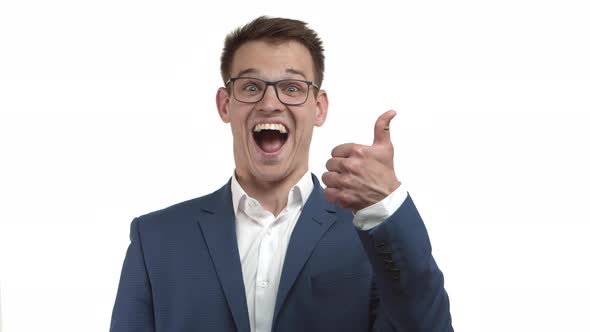 Attractive Happy Businessman in Blue Suit and Glasses Looking Excited and Showing Thumbsup Smiling