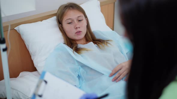 Portrait of Teenage Girl Lying in Bed with Eye Dropper Talking Complaining Pain