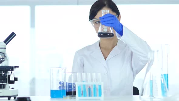 Woman Scientist Busy Doing Research and Reaction in Laboratory