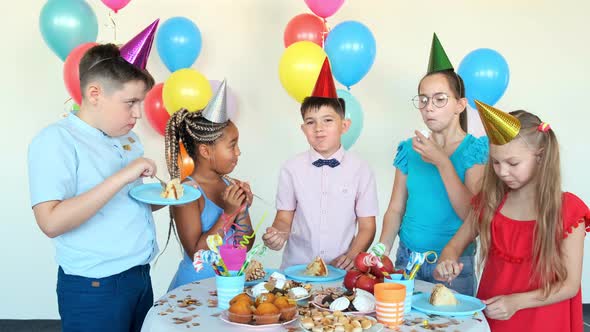 Children Eat Tasty Snacks Celebrating Birthday at Table