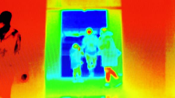 Covid-19 Prevention, Coronavirus Concept. Thermal Image of People Passing Through a Public Area