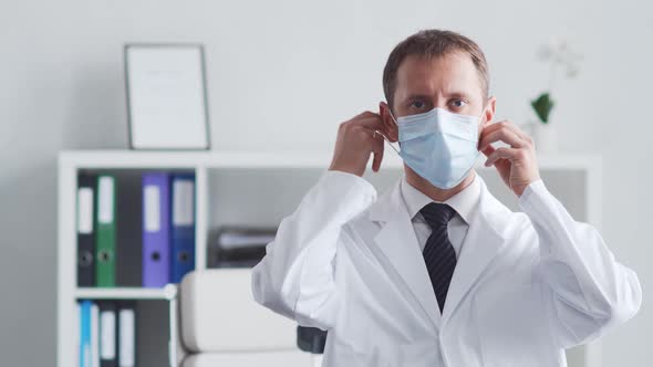 Professional medical doctor working in hospital office using computer technology.