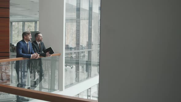 Businessmen in Suits Talking in Office