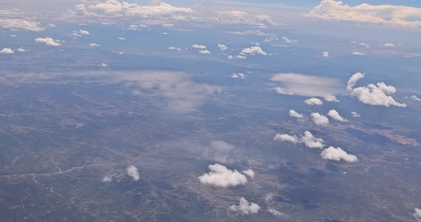 View From Plane During Flight Over of Fluffy Clouds desertNew Mexico USA