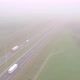 Overhead View of Cars Driving on a Highway Next to a Railroad on a Misty Day During Summer in - VideoHive Item for Sale