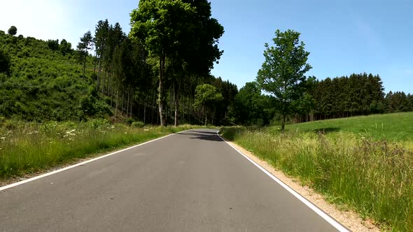 POV Driving on motorcycle on a scenic road in Eifel National Park in Germany