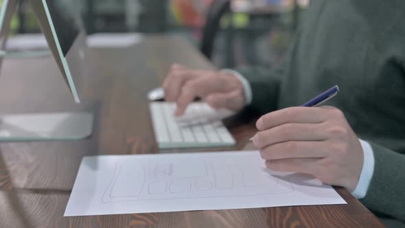 Close Up Shoot of Man Hand Making Notes and Using Keyboard