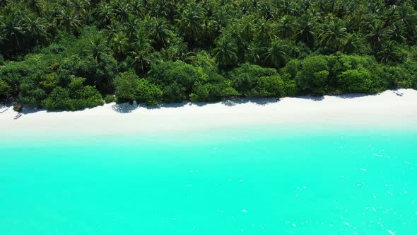 Shining turquoise lagoon with calm clear water washing white sand of exotic beach on tropical island