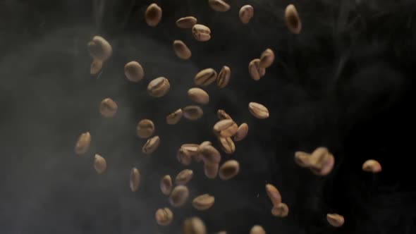 A Coffee Beans Falling in Slow Motion on Black Background With Smoke