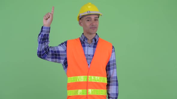 Happy Multi Ethnic Man Construction Worker Pointing Up