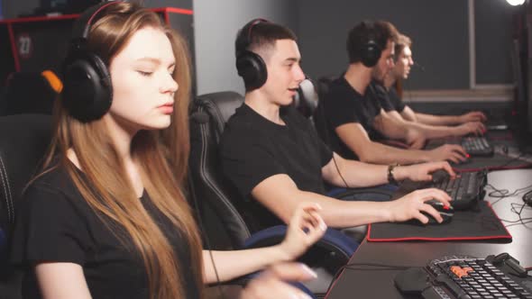 Woman in Team of eSport Gamers Playing Video Games on a Cyber Games Contest.