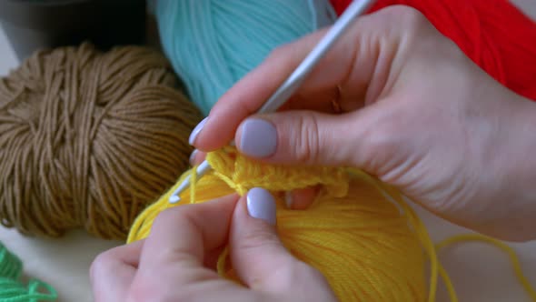 The Girl Learns To Crochet Yellow Thread